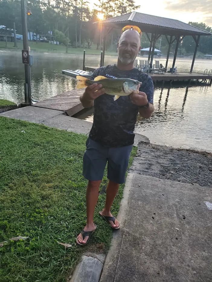 Matt holding a largemouth beside the dock on Chickamauga Lake