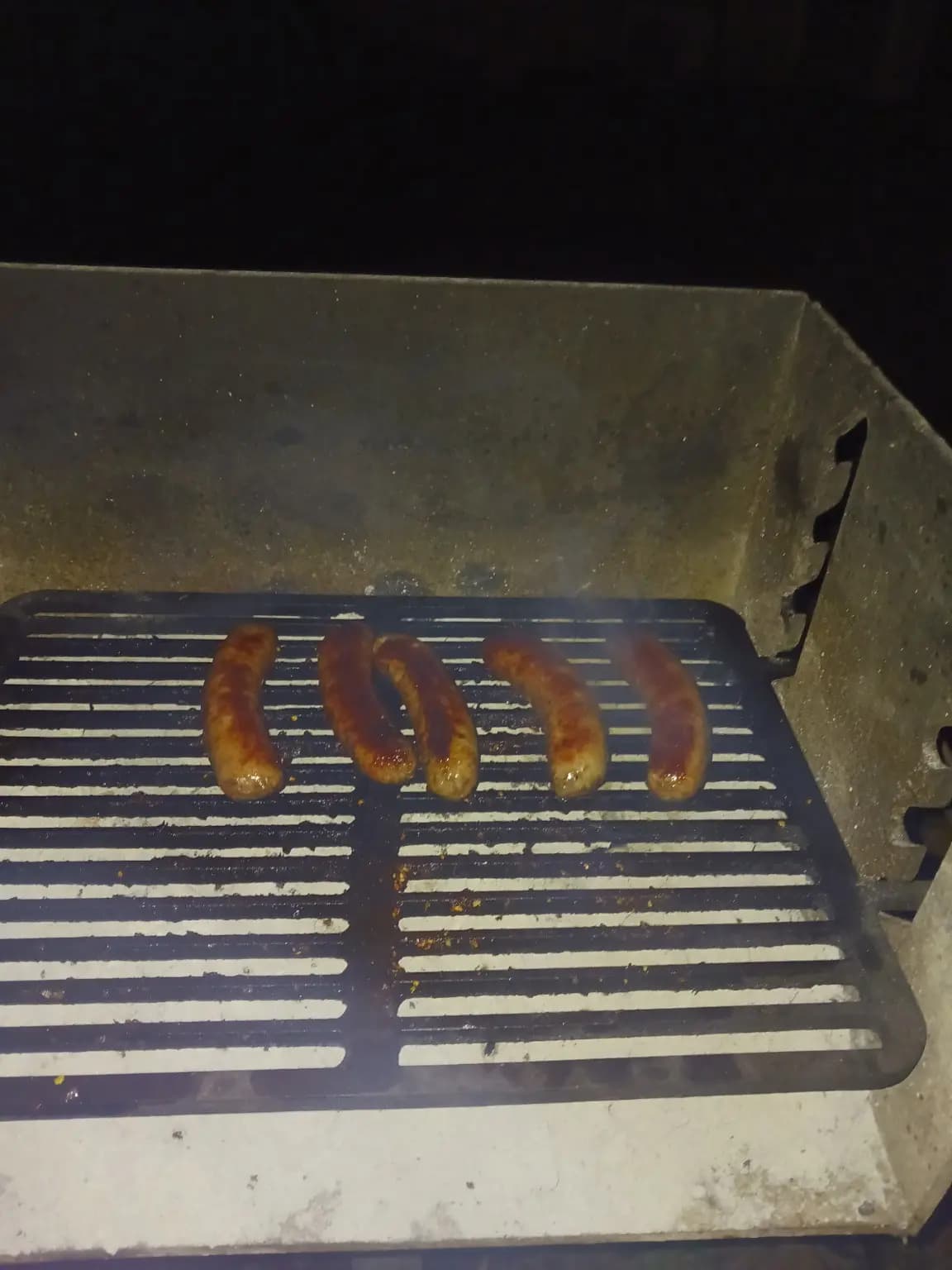 Sausages cooking on the cabin grill