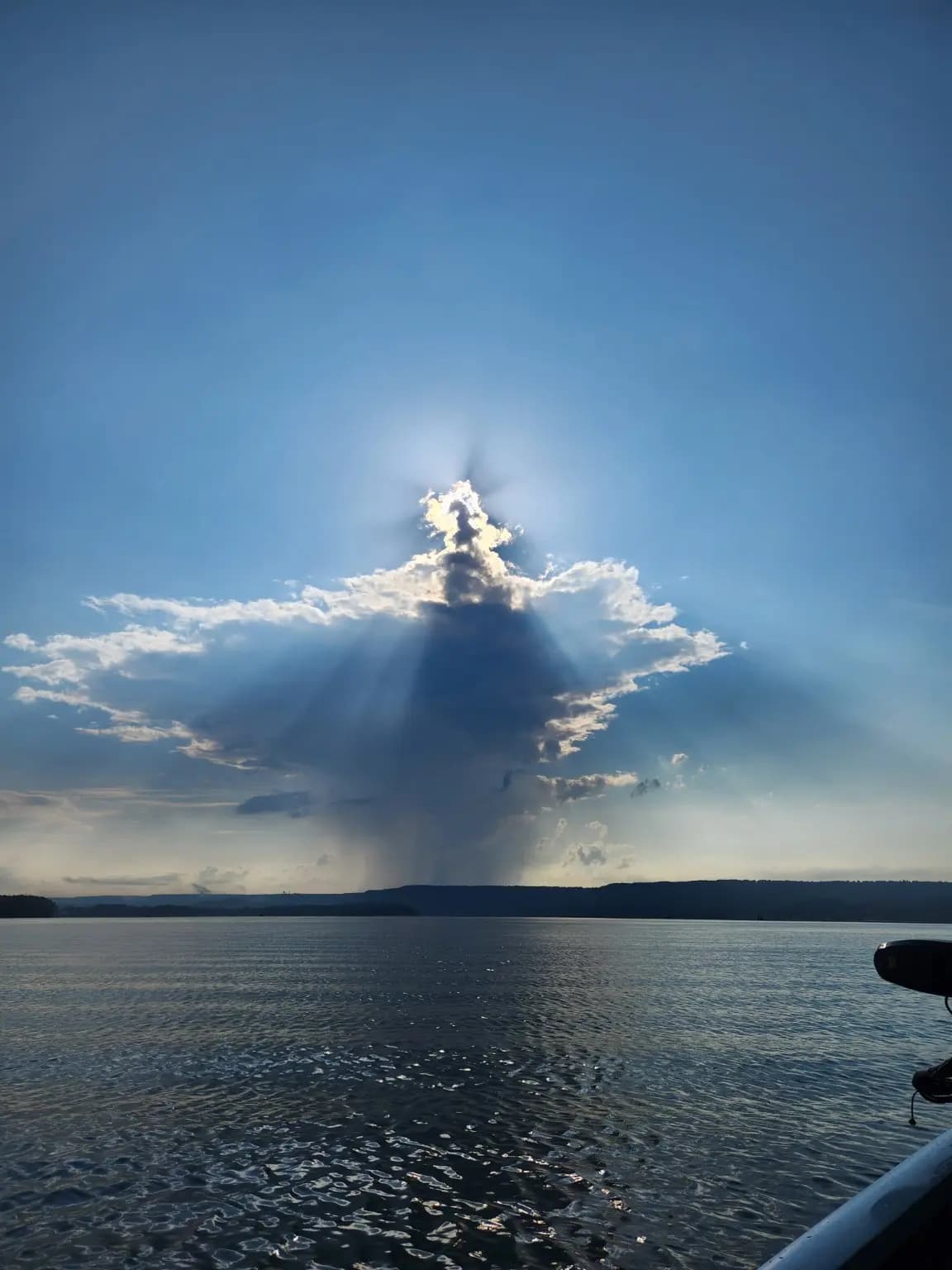 Sun rays breaking around a storm cloud over Lake Guntersville