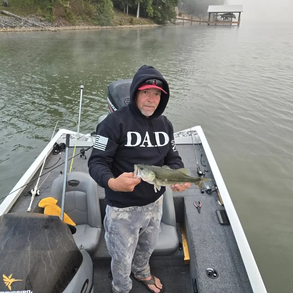 Mushy holding a largemouth in the rain on Chickamauga Lake
